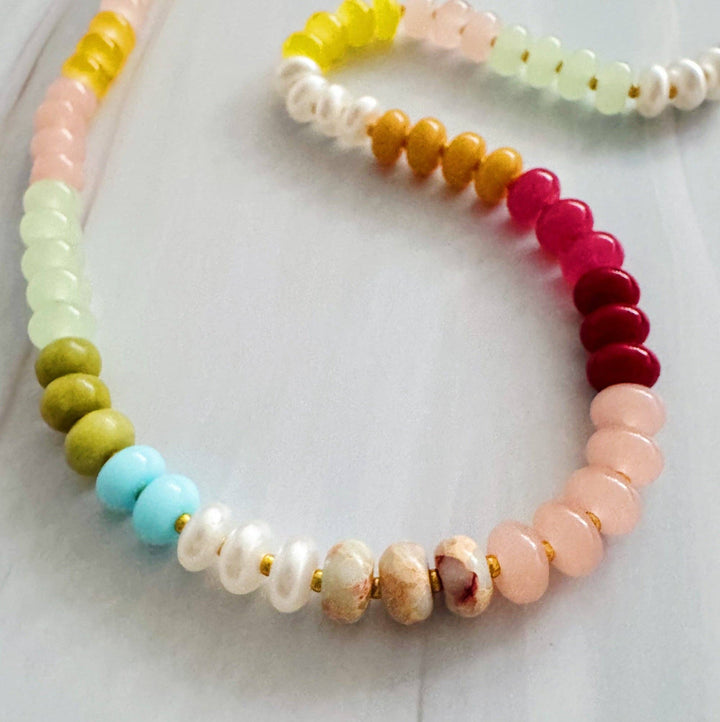 Colorful beaded bracelets on a light background