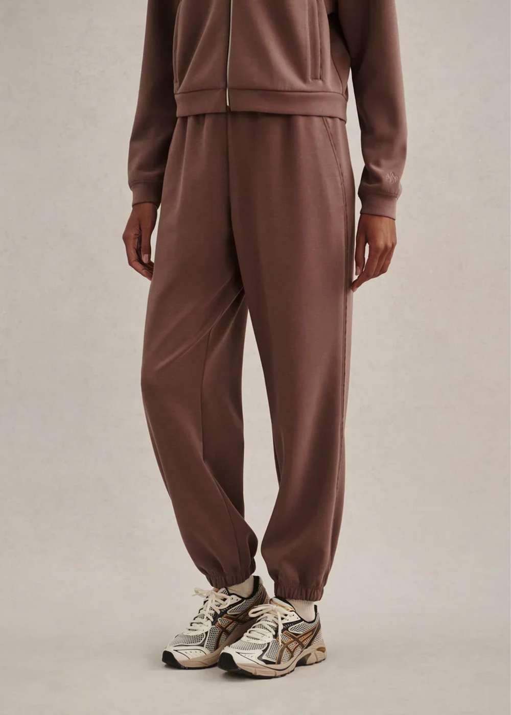 Woman wearing a brown colored matching sweat set. 