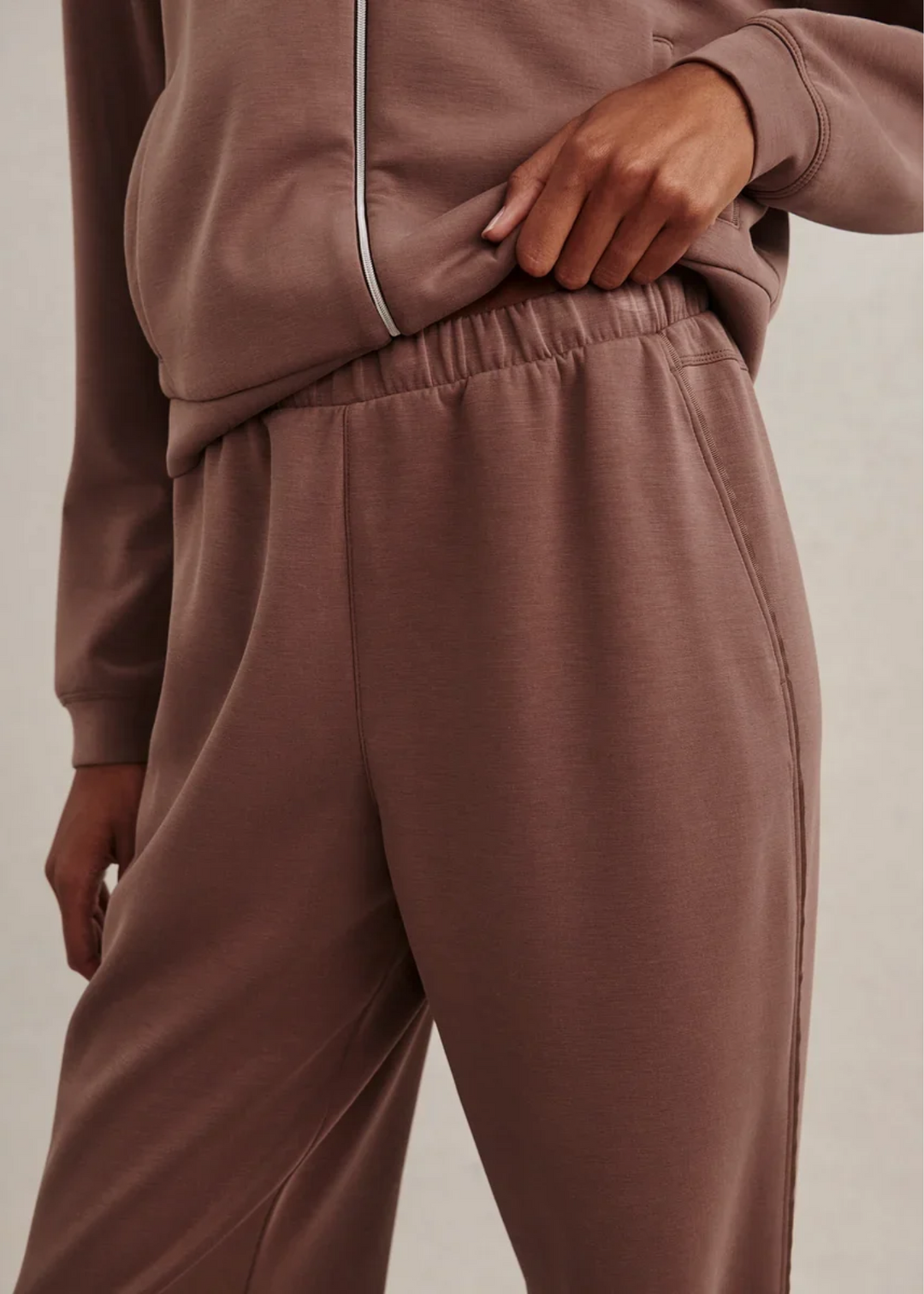 Woman wearing a brown colored matching sweat set. 
