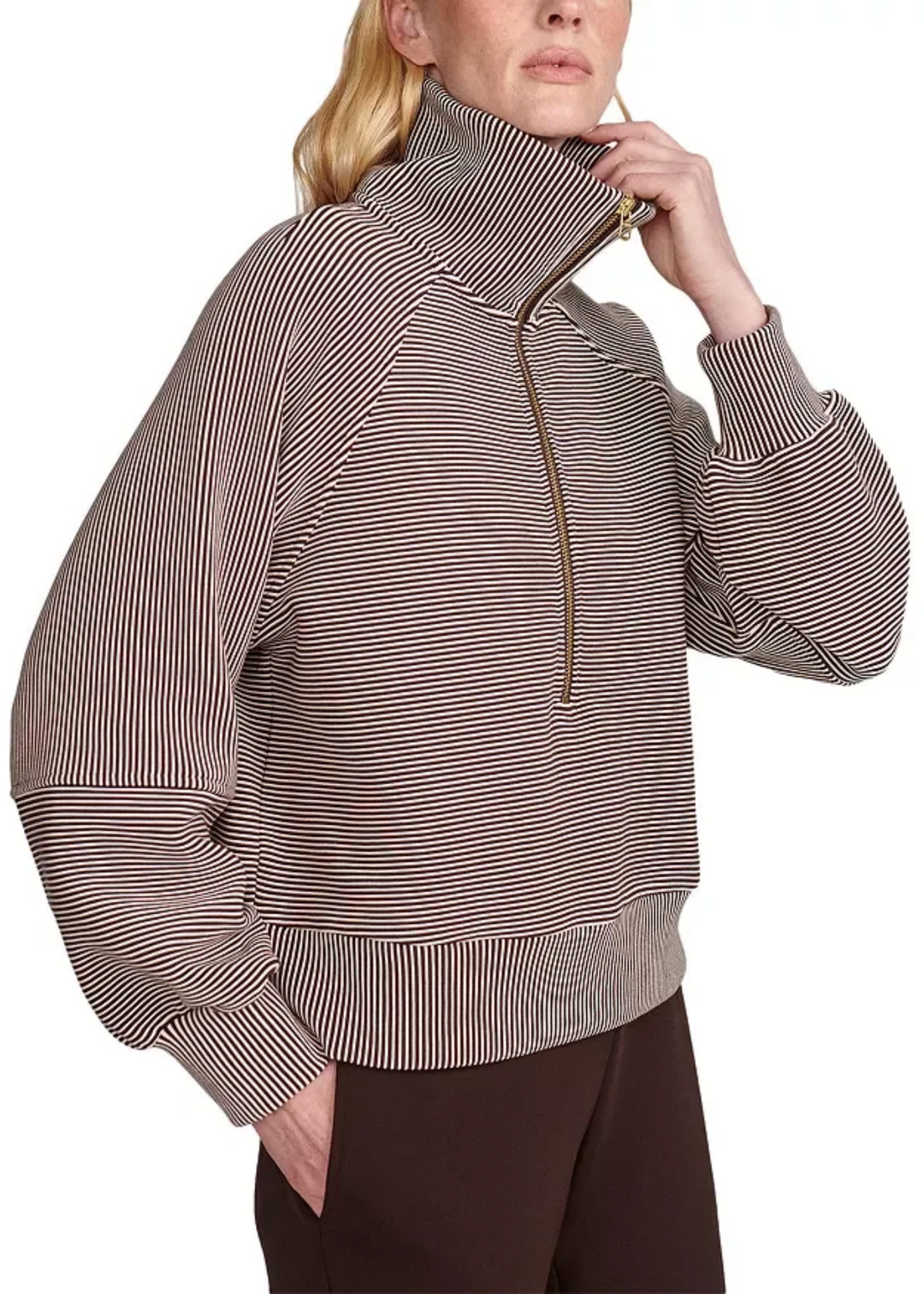 Woman hooding the color of a striped coffee bean/birch half zip. 