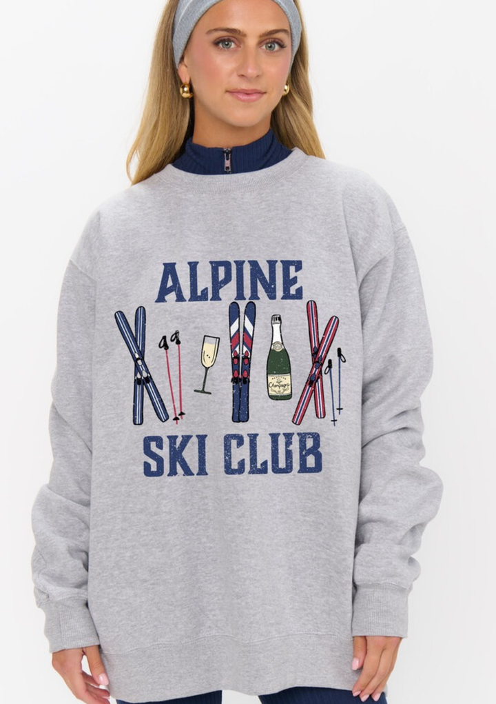 Woman wearing a gray sweatshirt with 'Alpine Ski Club' design on a white background