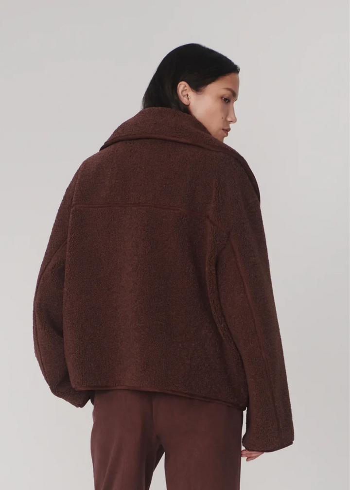 Woman wearing monochromatic outfit turned around.