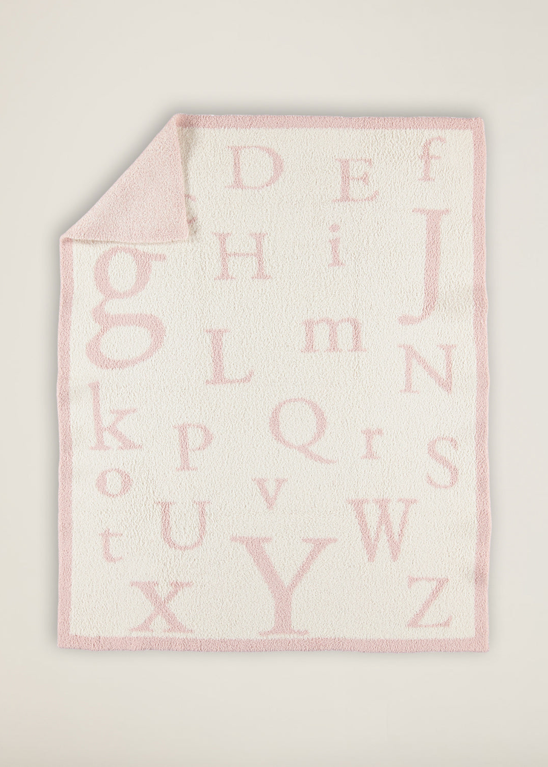 Pink and white ABC patterned blanket