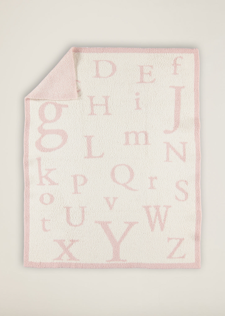 Pink and white ABC patterned blanket