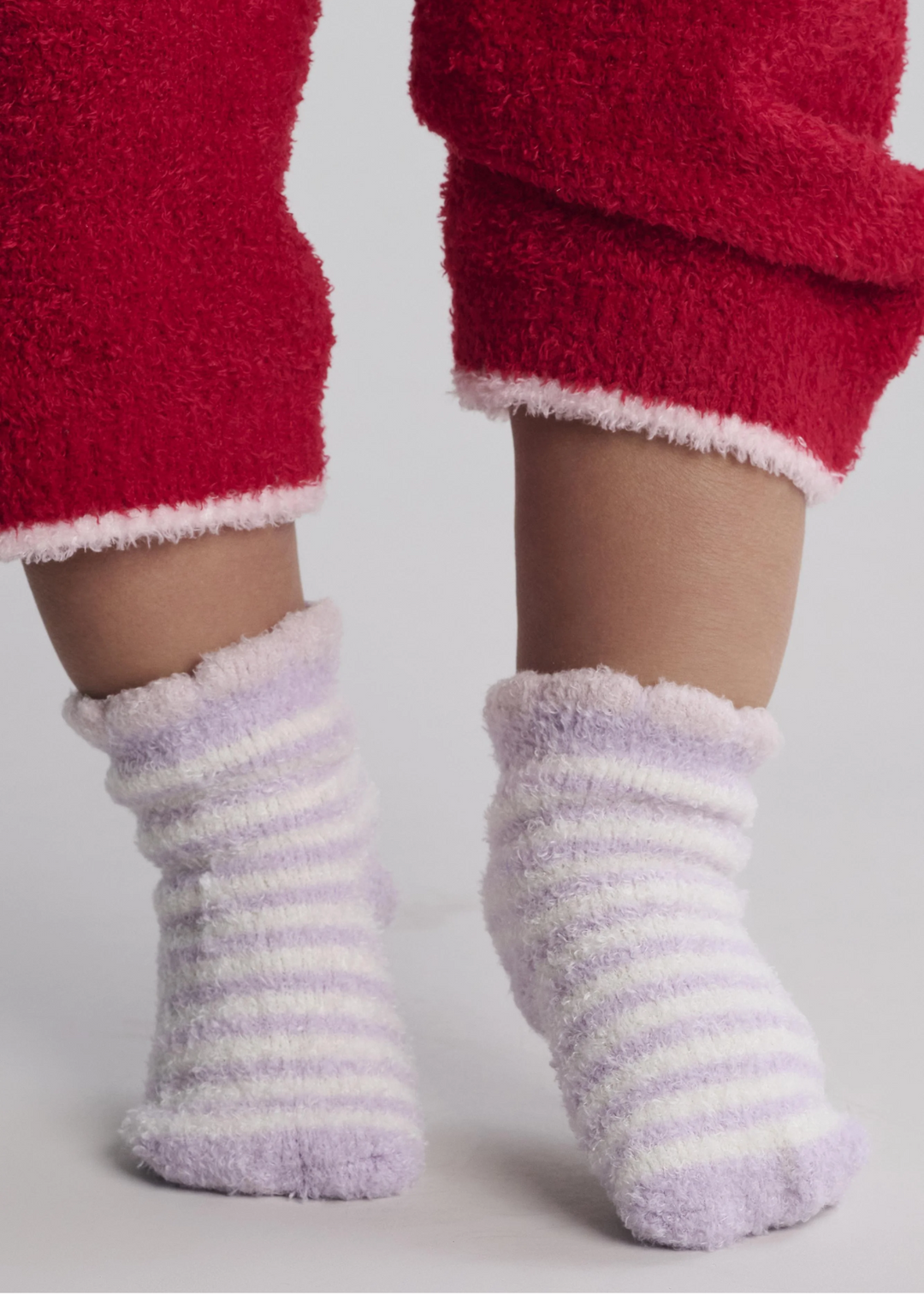 A baby wearing purple and white striped socks