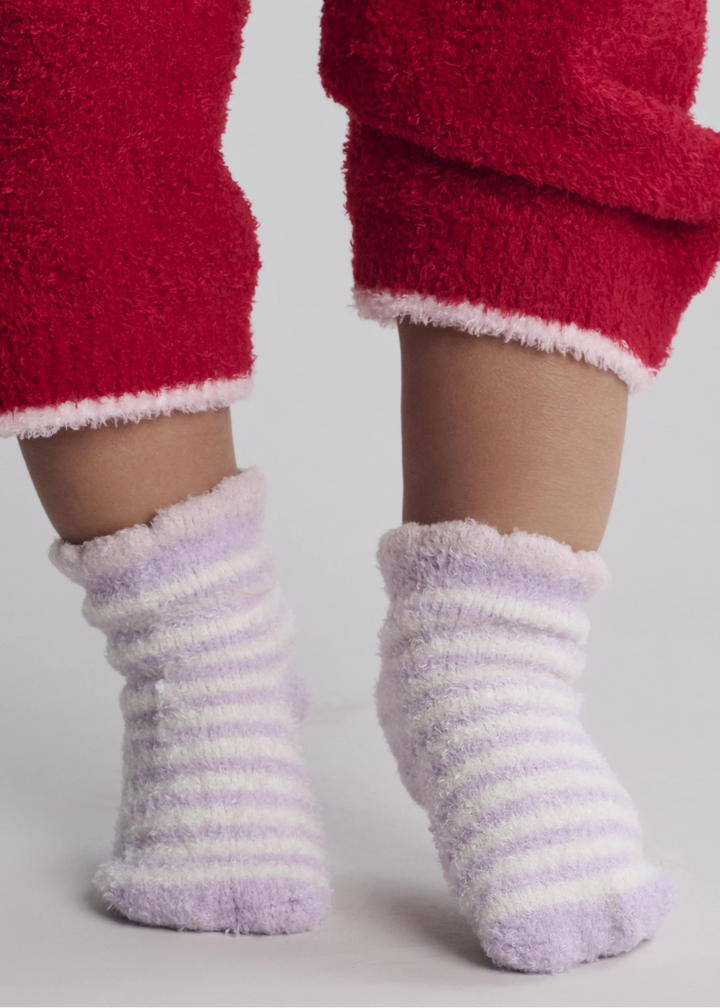 A baby wearing purple and white striped socks