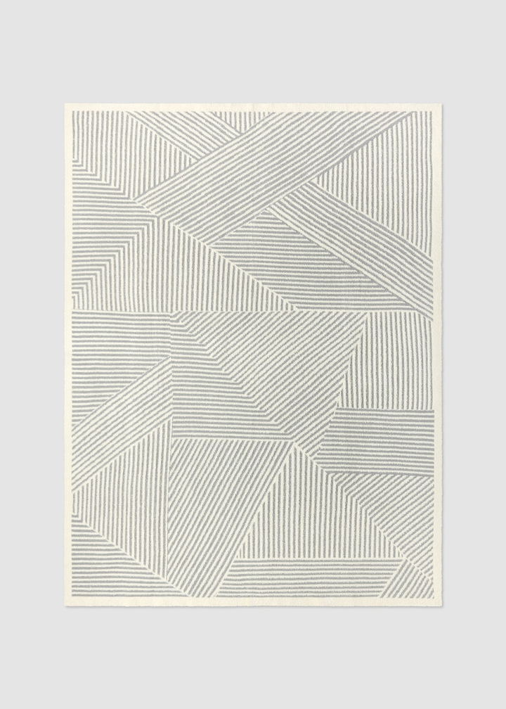 Grey and white striped blanket on a grey background