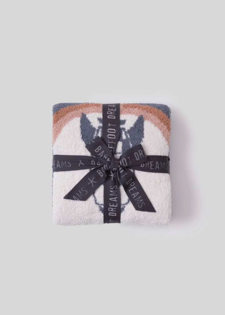 Folded blanket with a spaceship design with a charcoal grey bow on a white background