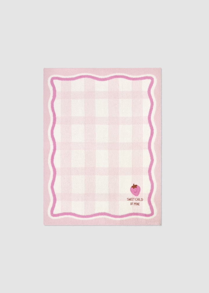 Pink baby blanket with a plaid pattern and an embroidered strawberry graphic