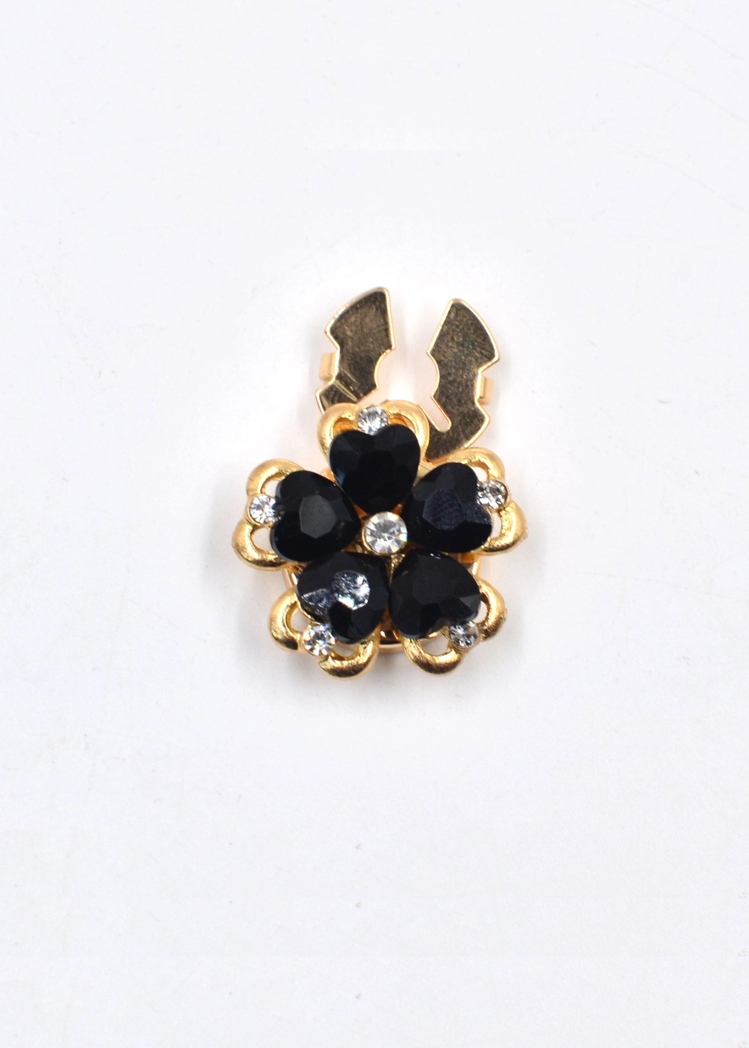 Gold and black flower shaped button cover on a white background