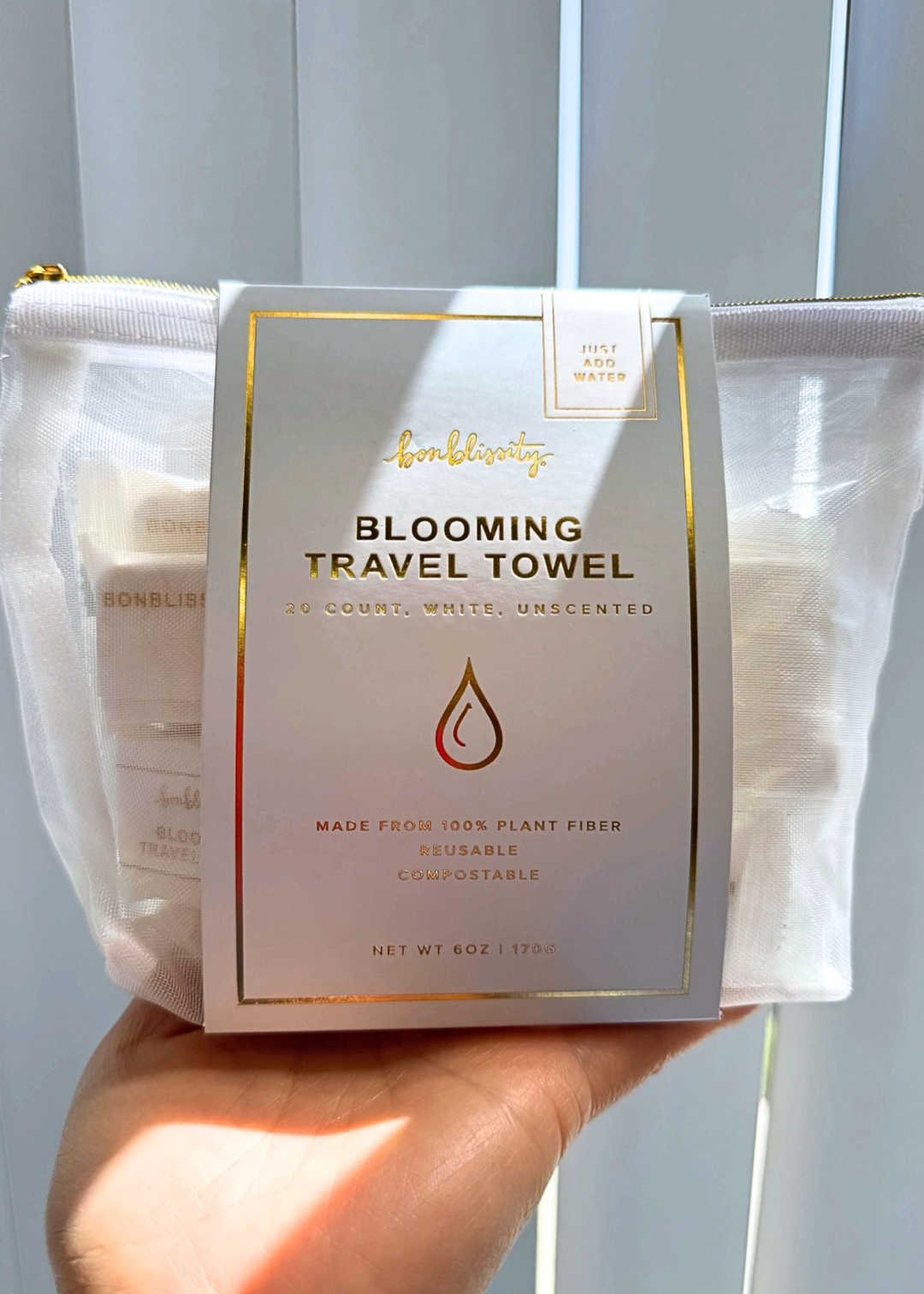 Hand holding a travel towel pack bag