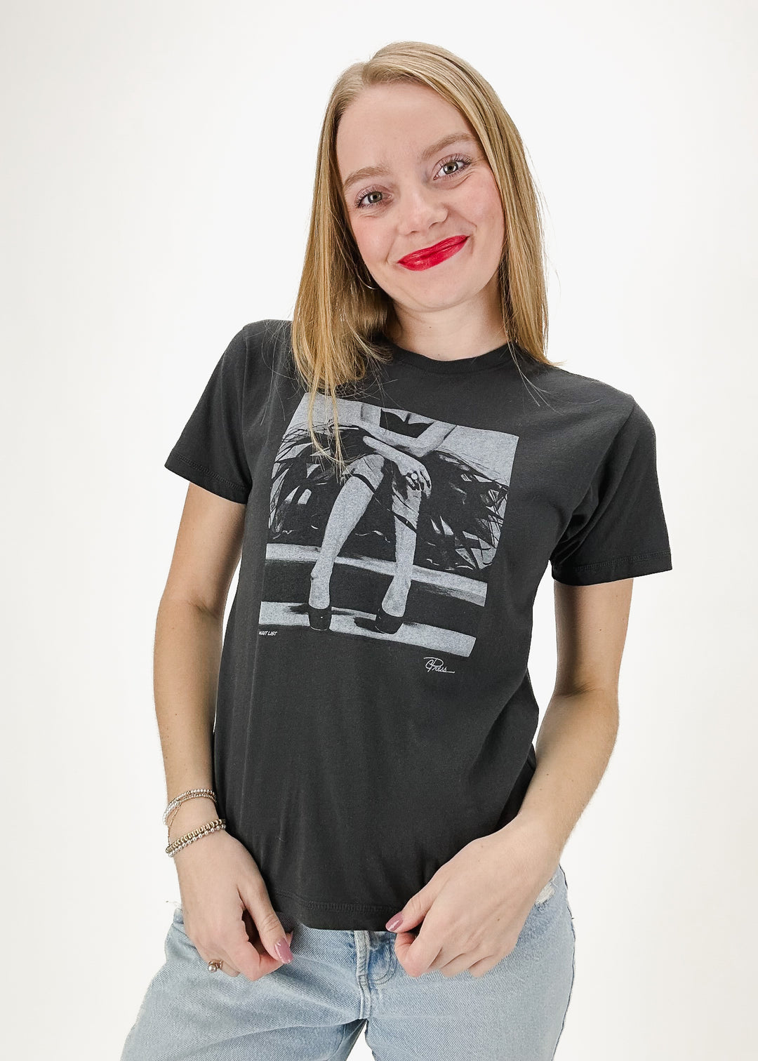 black tee shirt with artsy legs graphic on chest