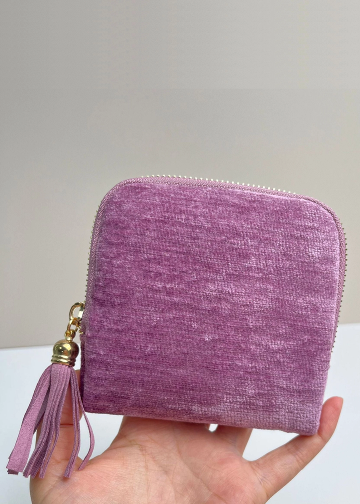 Hand holding a purple velvet jewelry organizer