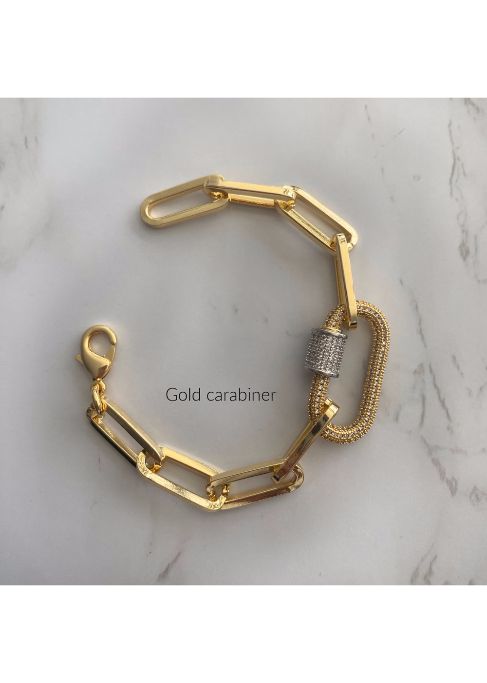 Gold paperclip chain bracelet with a gold carabiner