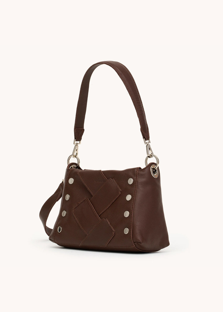 Brown leather woven purse with silver hardware on a white background