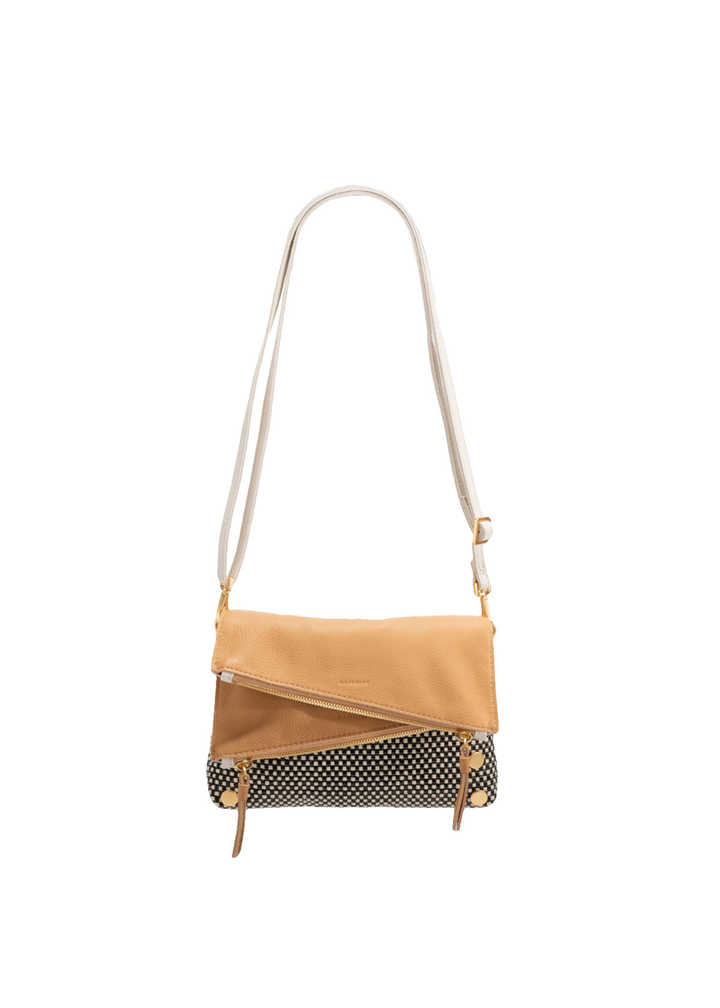 White, tan, and black handbag with gold accents against a white background