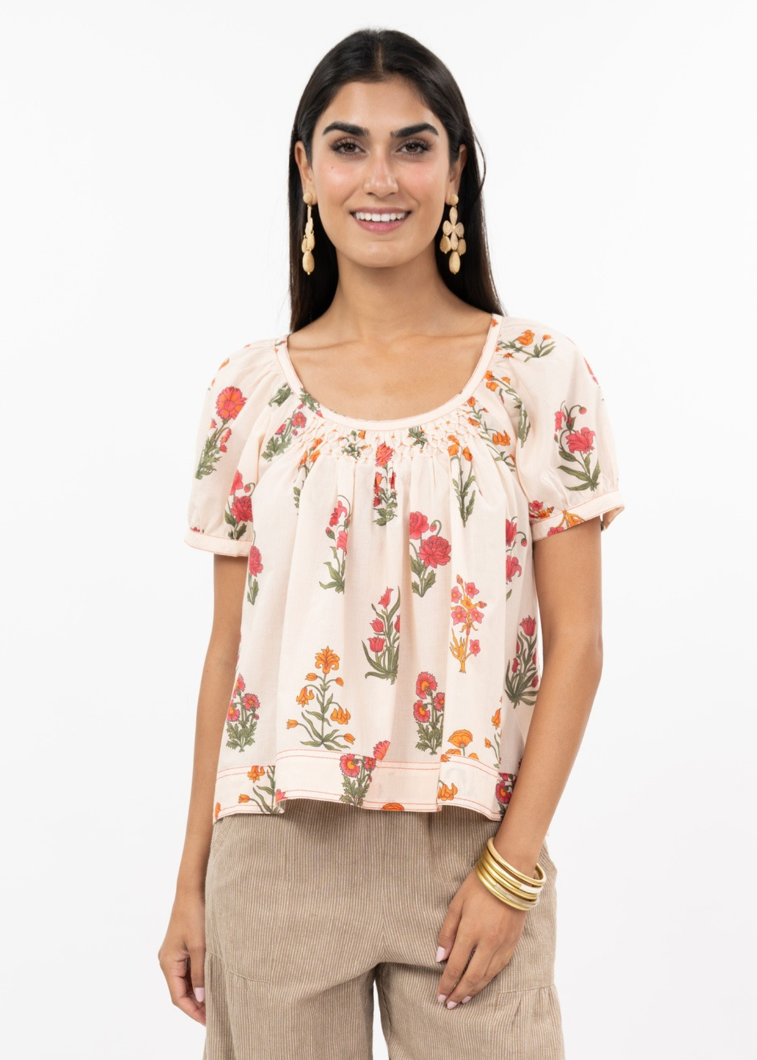 Woman wearing a floral top with brown pants