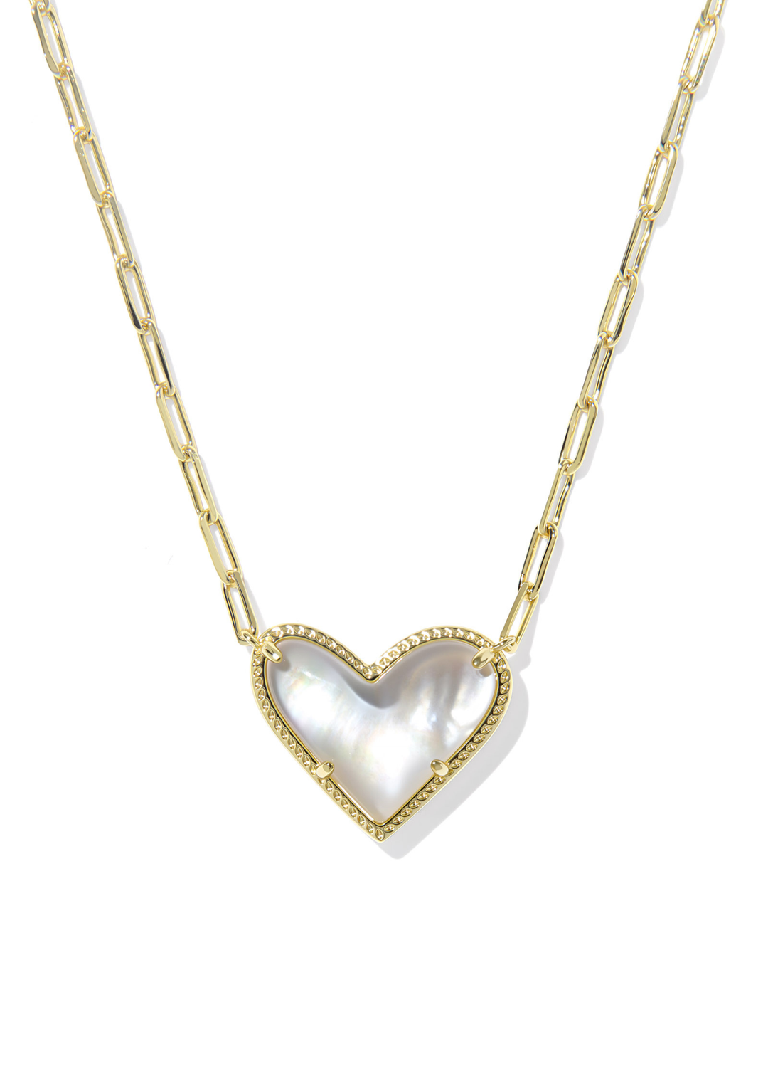 Gold necklace with an ivory, gold framed, and heart shaped pendant against a white background