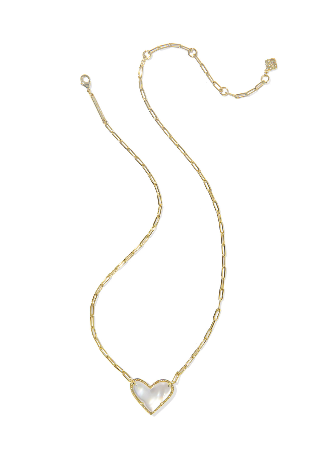 Gold necklace with an ivory, gold framed, and heart shaped pendant against a white background