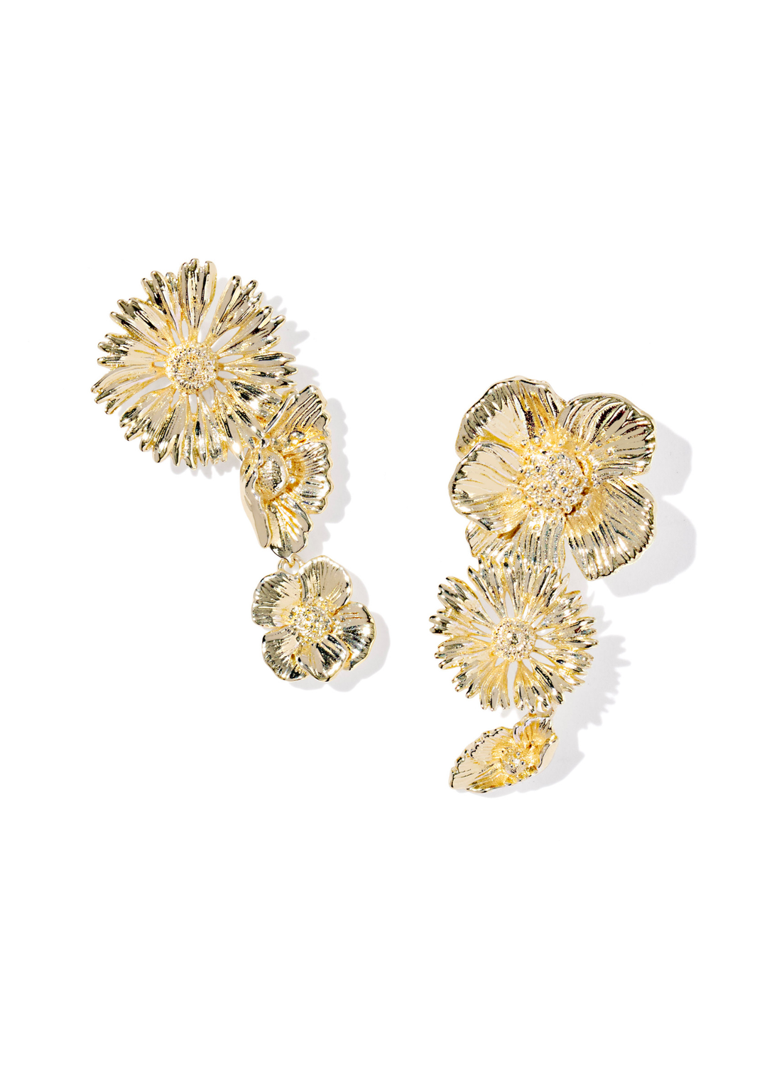 Gold flower shaped earrings on a white background