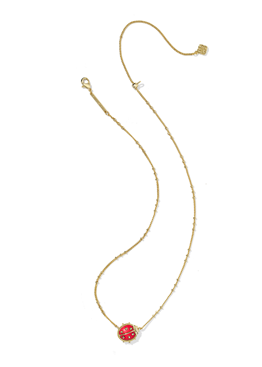 Gold necklace with a red ladybug pendant on a white background
