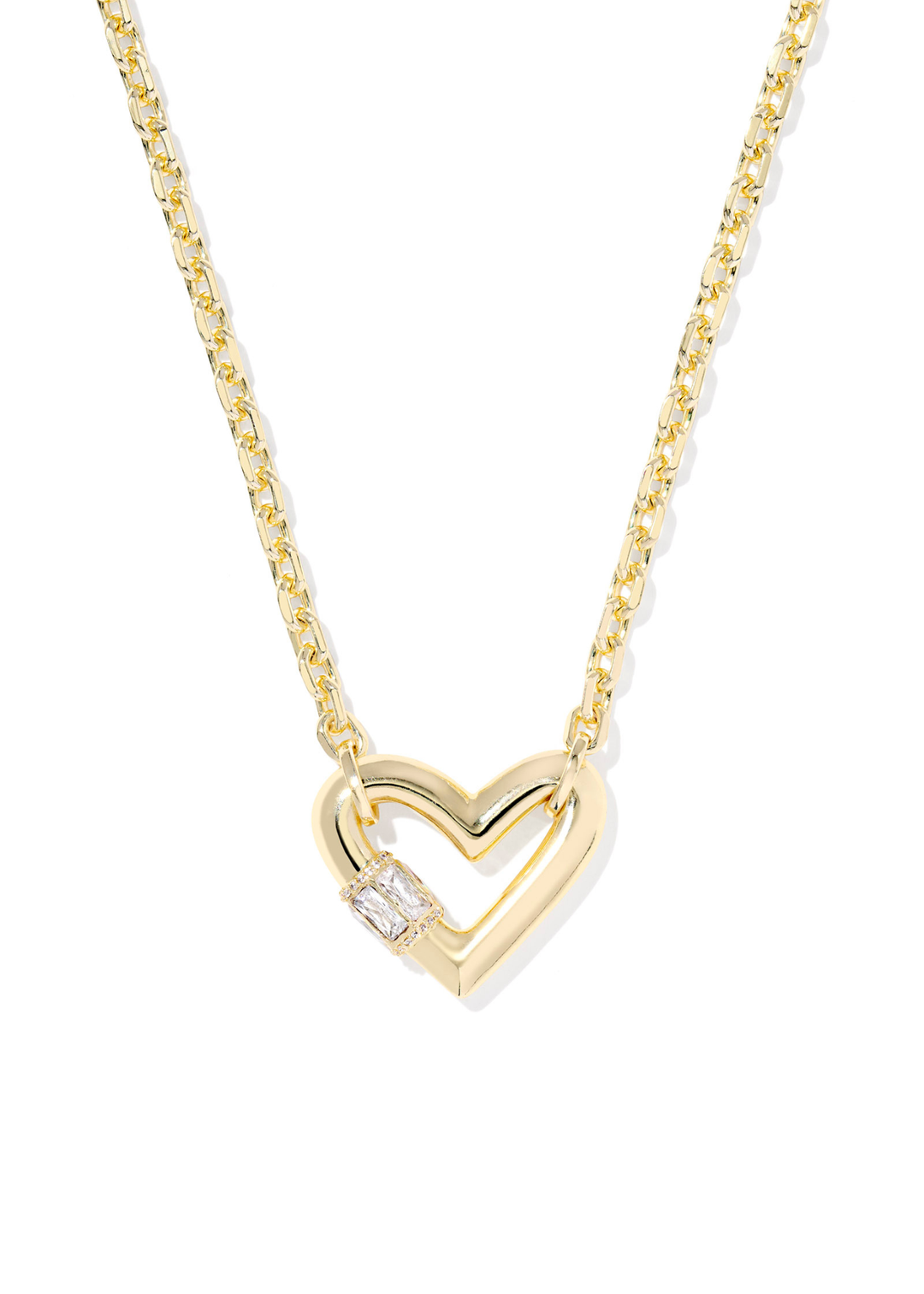 Gold necklace with a heart shaped pendant laying on a white background