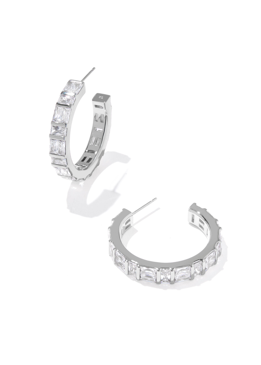 Silver hoop earrings with clear CZ studding on a white background
