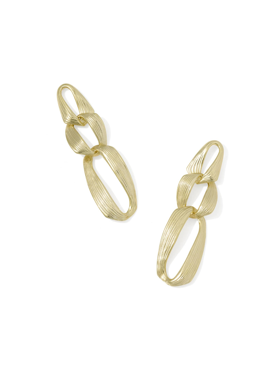 Gold statement earrings on white background