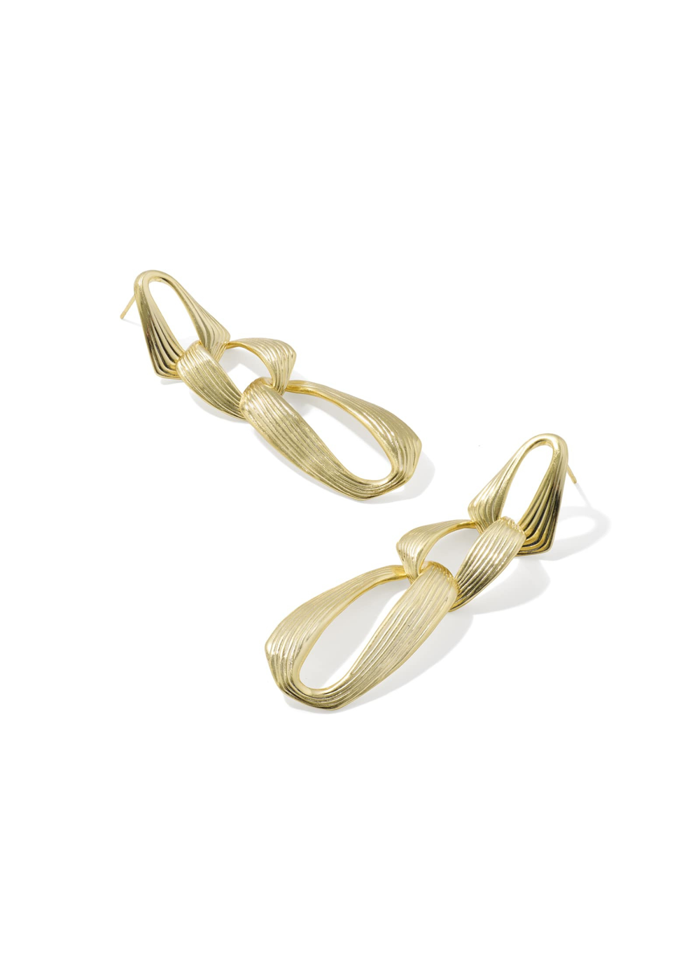 Gold statement earrings on white background