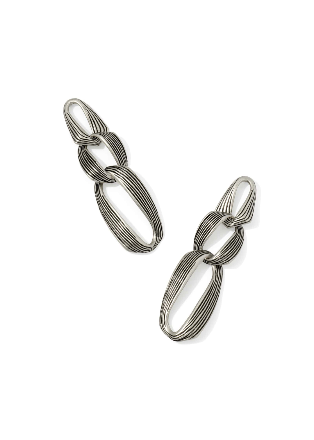 Silver statement earrings on a white background