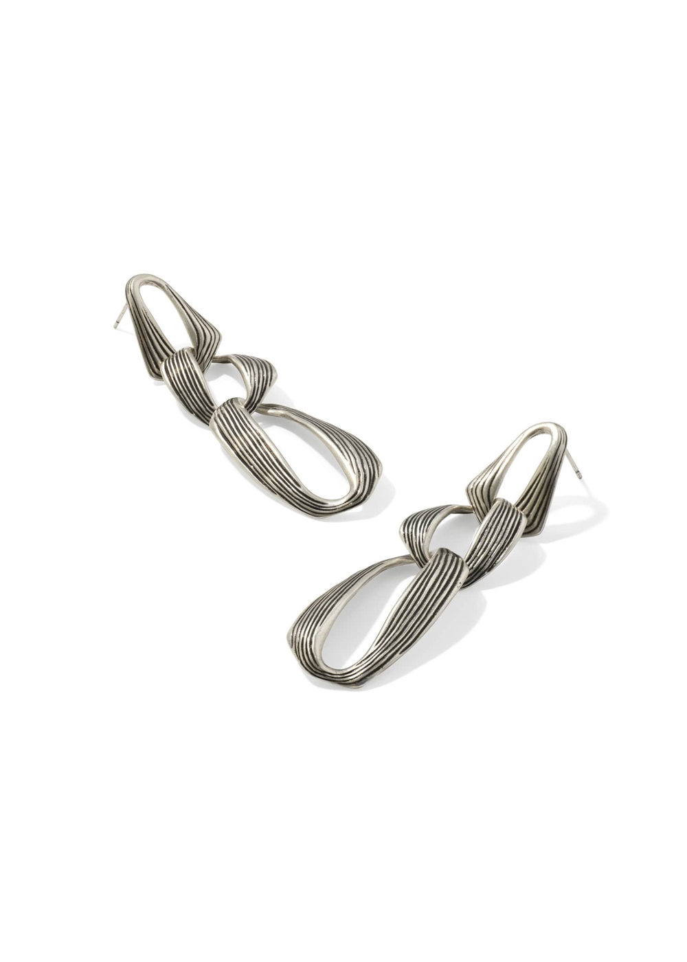 Silver statement earrings on a white background