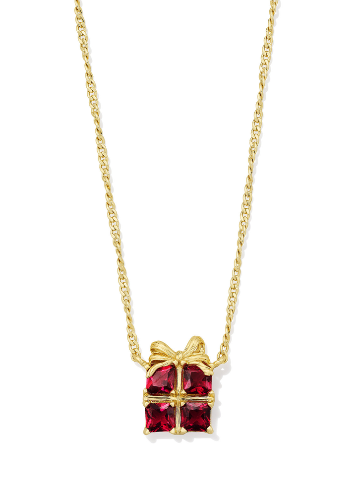 Gold necklace with a red present shaped pendant on a white background
