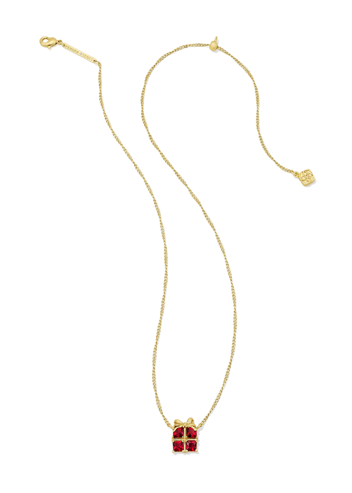 Gold necklace with a red present shaped pendant on a white background