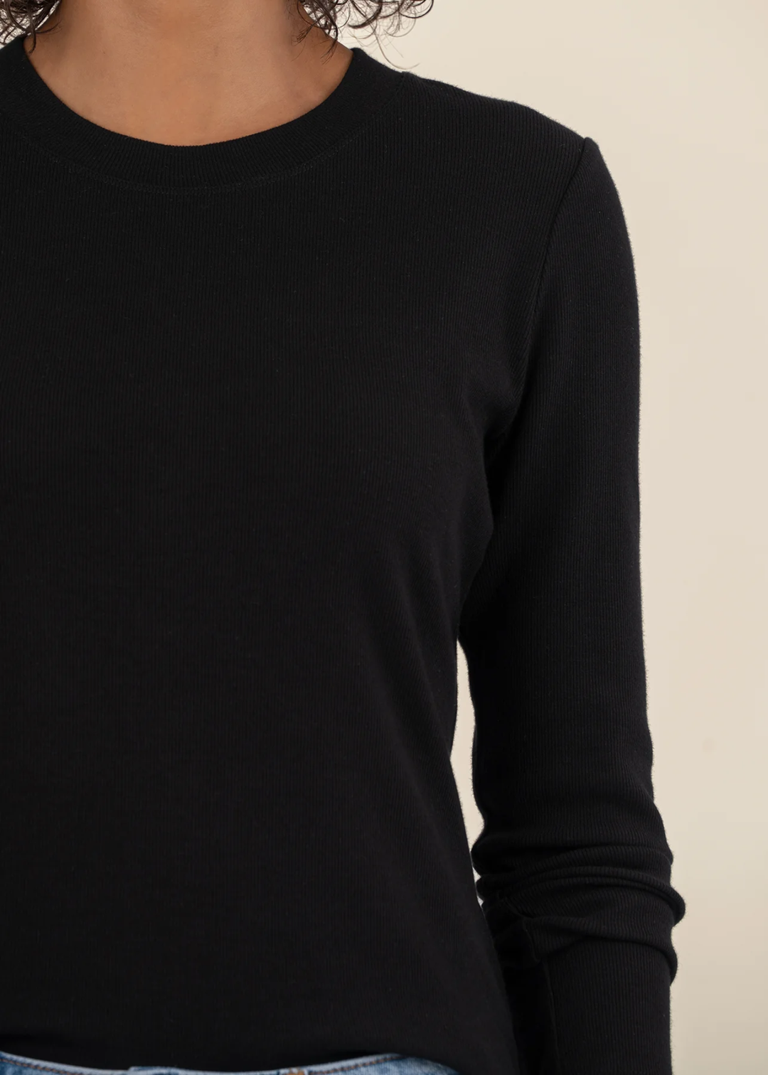 Close up of a woman wearing a black long sleeve tee