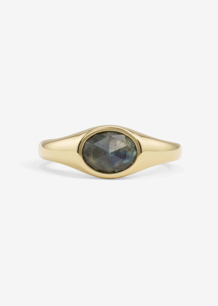 Gold signet ring with a labradorite stone on a white background