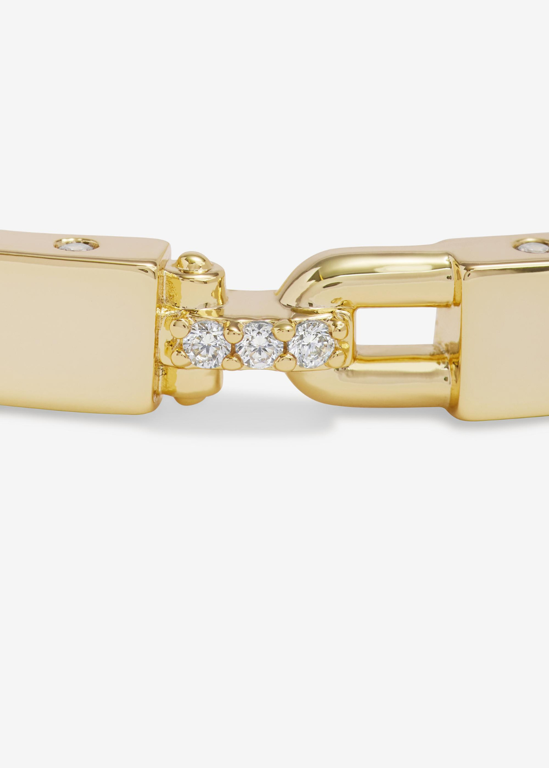 Close up of a lock clasp on a gold cuff bracelet 