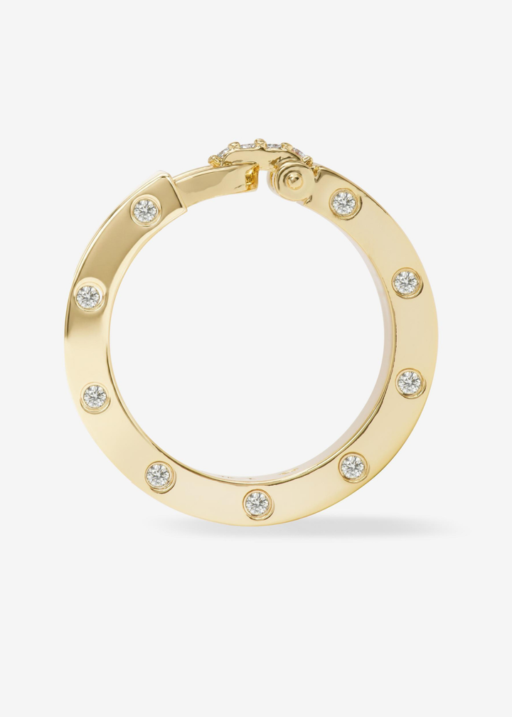 Gold band ring with CZ studding and a lock clasp on a white background