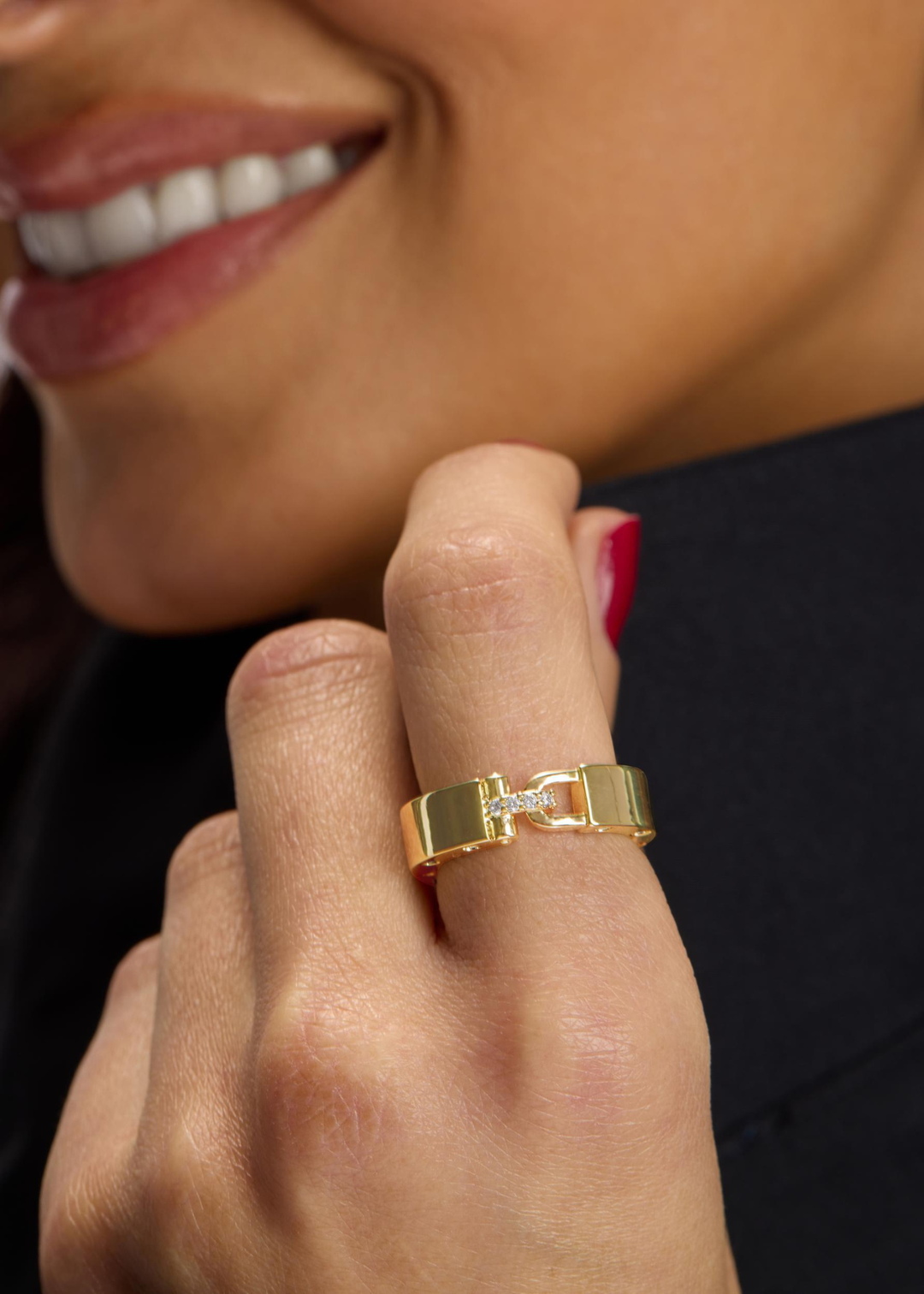 Woman wearing a gold band ring with CZ studding and a lock clasp