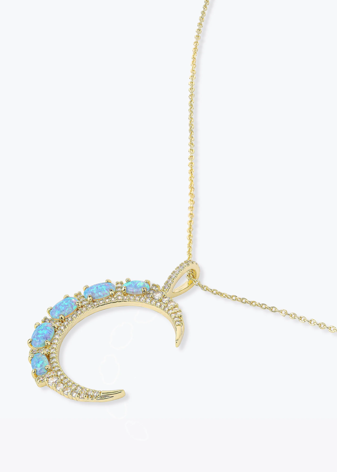Gold necklace with a gold moon pendant with blue opal studs