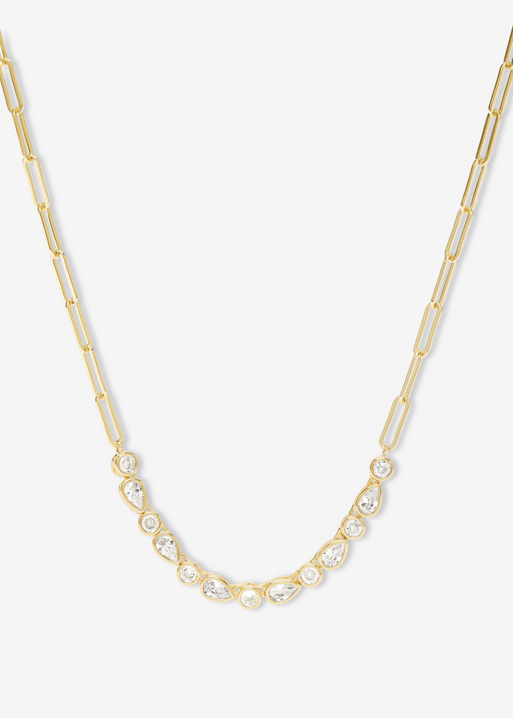 Gold chain necklace with white CZ stones on a white background