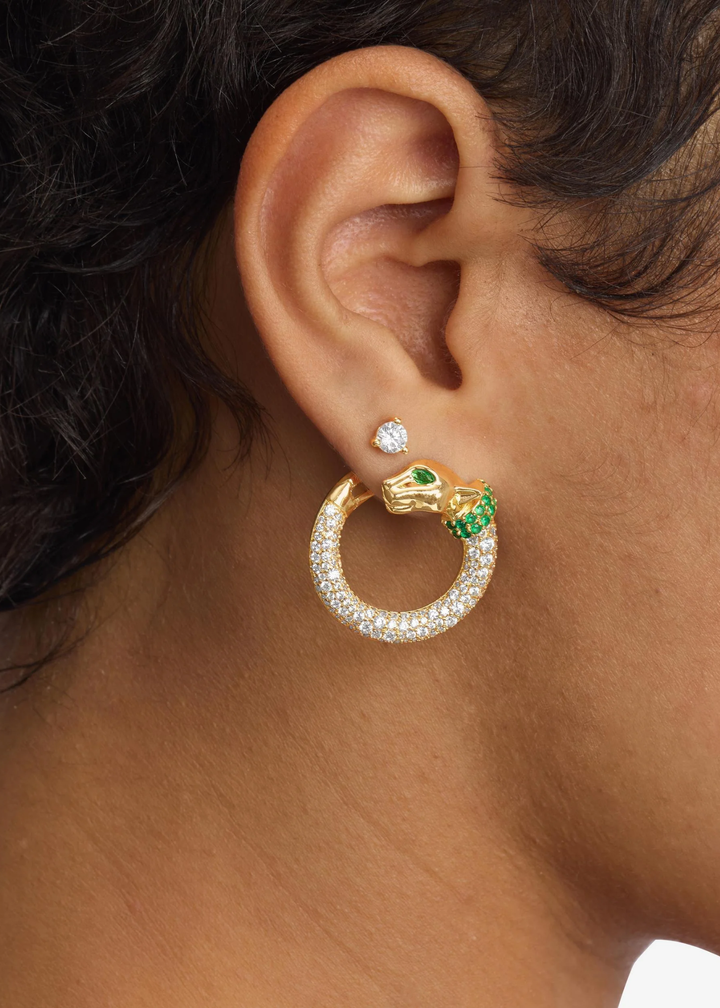 Woman wearing gold and emerald pave and jaguar shaped hoop earrings