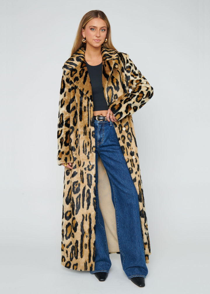 Woman wearing a long leopard print faux fur coat
