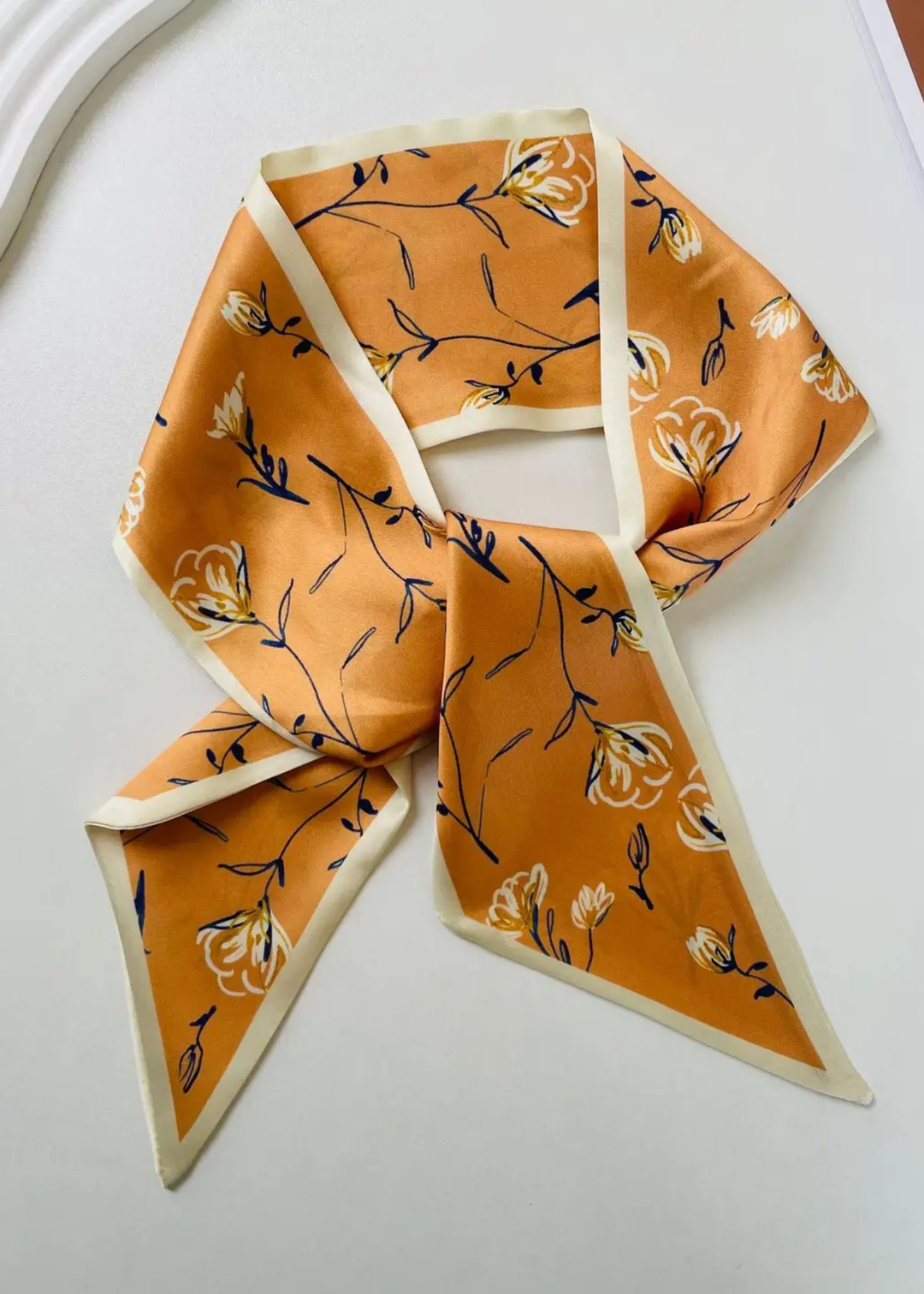 Yellow floral satin scarf on a white background