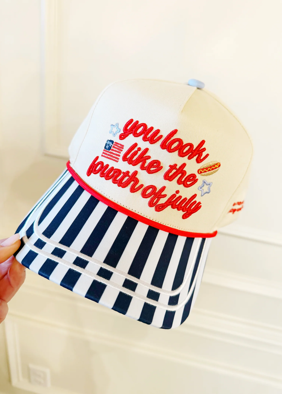 Hat with a "You look like the fourth of july" graphic lettering and stripes