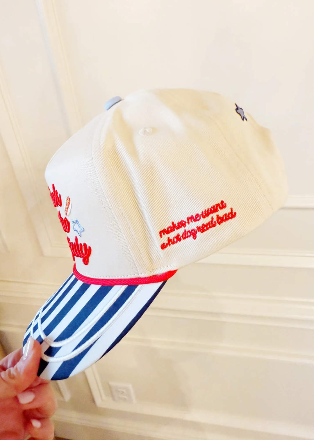 Hat with a "makes me want a hot dog real bad" graphic lettering and stripes