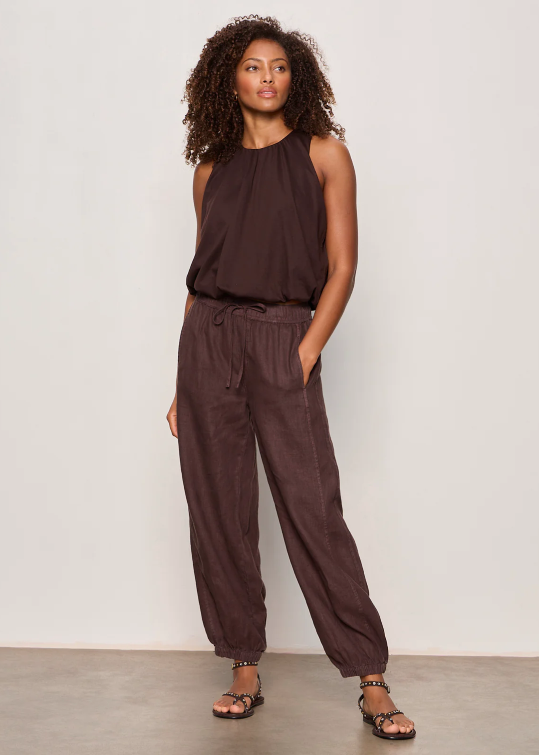 Woman wearing a brown tank top with matching pants