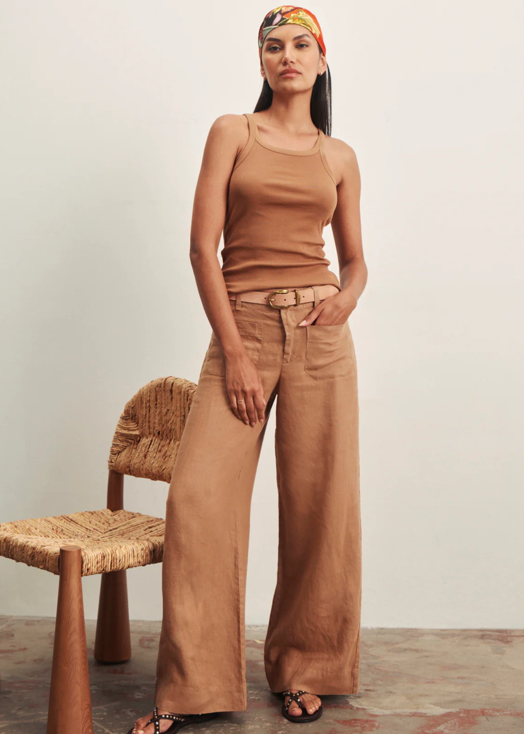 Woman wearing brown wide leg pants with a brown tank top