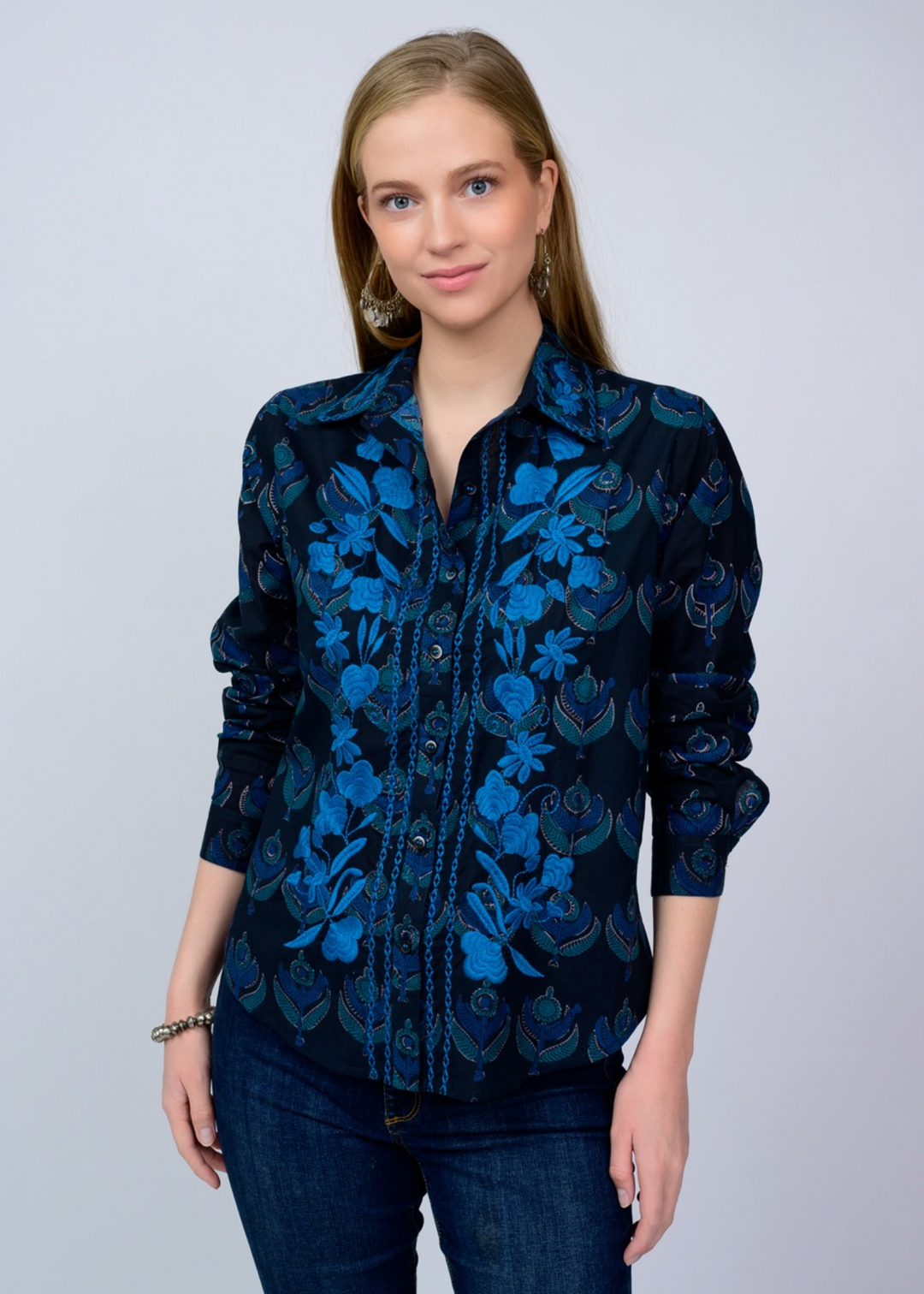 Woman wearing a navy blue floral button down top