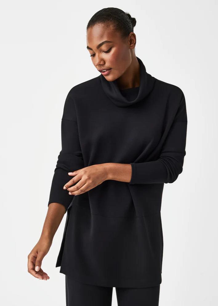 Woman wearing the Spanx AirEssentials Turtleneck Tunic in black