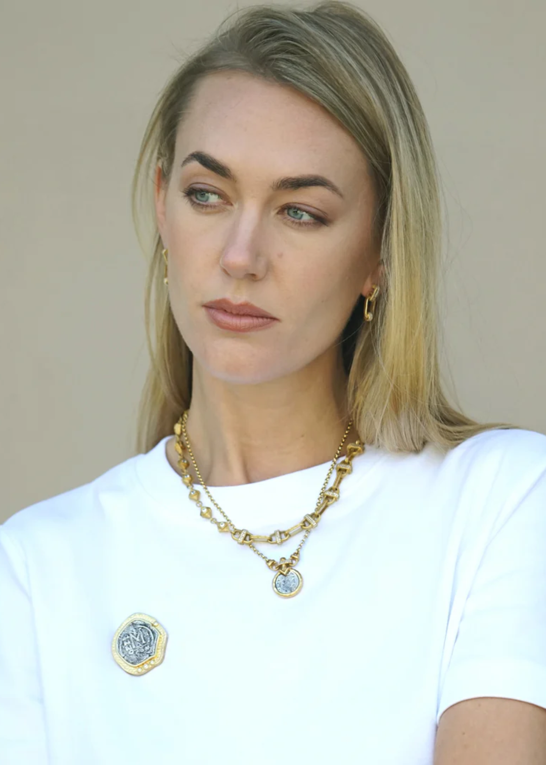 Woman wearing a gold chain necklace with other necklaces